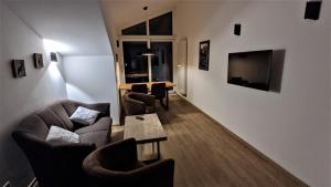 ein Wohnzimmer mit Sofas, Stühlen und einem Tisch in der Unterkunft Ferienhaus Wetterstein in Grainau