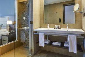 a bathroom with a sink, toilet and shower stall at Riu Dubai - All Inclusive in Dubai