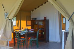 a dining room with a table and chairs at Glamping Tenuta San Pierino Agriturismo in Rosignano Marittimo +52 photos