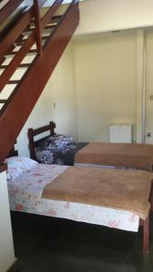 Säng eller sängar i ett rum på Pousada Chico Taquara