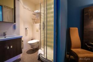 a bathroom with a toilet and a sink at Élysée Hôtel in Châteauroux