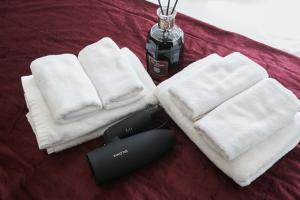 un par de toallas y un mando a distancia en una cama en HOTEL AIS HATAGAYA, en Tokio