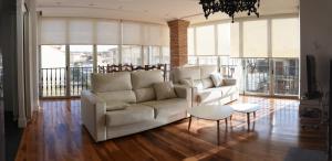 a living room with a white couch and a table at Bodega Don Balbino in La puebla de Labarca 