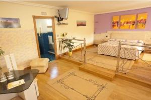 a living room with a bed and a table in it at Hotel Holiday in Nigrán