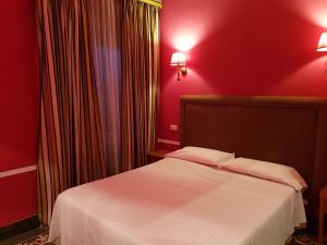 Postel nebo postele na pokoji v ubytování Hotel Kennedy