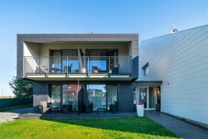 a house with a balcony with chairs on it at Spokojne Wczasy in Mielno