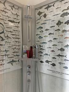 a bathroom with a wall with fish on it at ApartmentInCopenhagen Apartment 1107 in Copenhagen