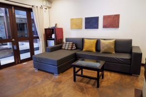 a living room with a couch and a table at Sunny V Hotel in Chiang Mai