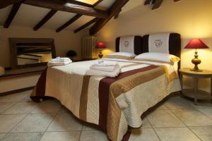 a bedroom with a large bed with towels on it at Terrazza Ginori in Sesto Fiorentino