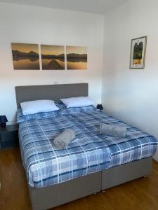 a bed in a bedroom with two pillows on it at Apartments Vidmar near Bled - Adults only in Lesce