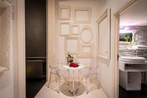 a dining room with a white table and chairs at Maison Noppius - Love Hotel in Liège +44 photos