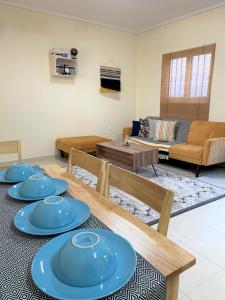 a living room with blue plates on a table at Boho Apartment near Athens Airport in Spáta