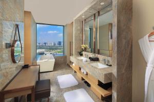 a bathroom with two sinks and a large window at InterContinental Taiyuan, an IHG Hotel in Taiyuan