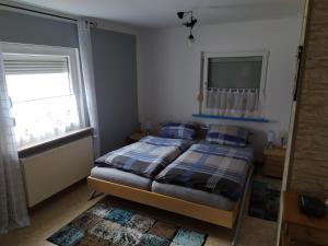a bedroom with a bed and a tv on the wall at Ferienwohnung Mitwitz Kronach Neustadt Coburg - Erholung, Wandern uvm. sehr ruhig gelegen in Mitwitz