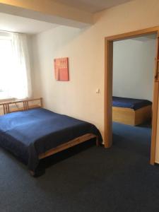 a bedroom with two beds and a mirror at VITA Ferienresidenz in Neu Kaliß