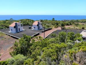 an aerial view of two white buildings with the ocean in the background at Vista Montanha in Madalena