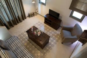 an overhead view of a living room with a couch and a television at Acquaterra Villas in Tsoukaladhes