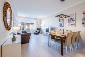 a dining room and living room with a table and chairs at Frame Apartment in Florence