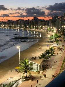 a view of a beach at night with a city at Cobertura Duplex Beira Mar Praia do Morro, Guarapari in Guarapari