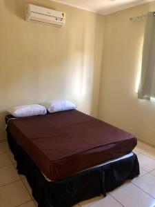 Een bed of bedden in een kamer bij Il Pevero Condominio AC