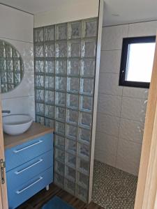 a bathroom with a blue cabinet and a sink at Le Petit Renard in Saint-Jouin-Bruneval