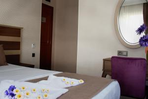 A bed or beds in a room at Sembol Hotel