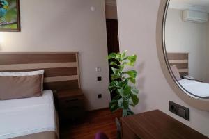 A bed or beds in a room at Sembol Hotel