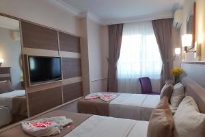 A bed or beds in a room at Sembol Hotel