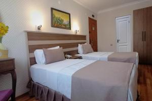 A bed or beds in a room at Sembol Hotel