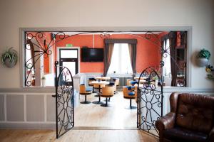 a living room with an open door with a table and chairs at Reftele Wardshus in Reftele