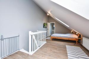 a bedroom with a bed and a stair case at Ostseedomizil Beachloft in Kellenhusen