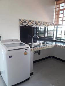 a kitchen with a sink and a faucet at Khun Pich Apartments in Siem Reap