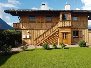 uma grande casa de madeira com uma grande escadaria em Haus am Pool - Wohlfühloase em Ohlstadt
