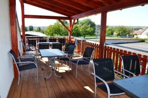 a patio with tables and chairs on a deck at Penzion Sedlecká vína in Sedlec