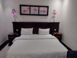 a bedroom with a large bed with two night stands at ديالا للشقق المخدومة1 in Riyadh +12 photos