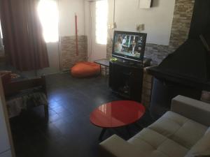 a living room with a television and a couch at mi pesadilla2 in Salinas 