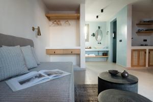 a living room with a couch and a table at Terra Nera Suites in Perivolos