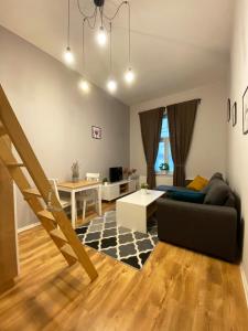 a living room with a couch and a table at Smart Rooms for Rent in Kraków