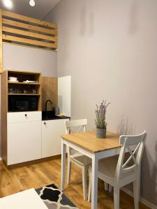 a kitchen and dining room with a table and chairs at Smart Rooms for Rent in Krakow