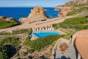 an aerial view of a resort with a swimming pool and the ocean at Le Sfumature di Melograno in Costa Paradiso