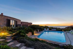 a swimming pool in the backyard of a house at Le Sfumature di Melograno in Costa Paradiso