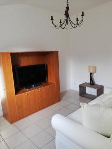 a living room with a couch and a tv at logement entier au calme in Villers-Outréaux