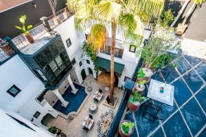 an overhead view of a house with a palm tree at Riad Makila in Marrakech
