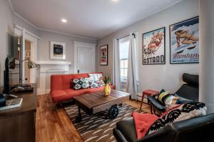 a living room with a red couch and a table at Haven on the Hill in Portland