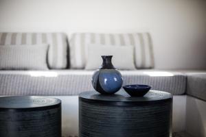 a blue vase sitting on a table in a living room at Terra Nera Suites in Perivolos