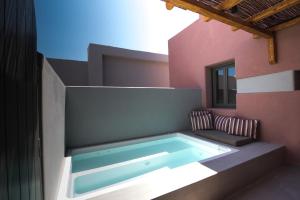 a swimming pool in a house with at Terra Nera Suites in Perivolos