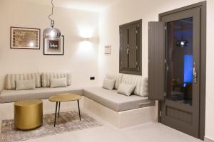 a living room with a couch and a table at Terra Nera Suites in Perivolos