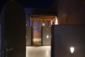 a view of a hallway with doors in a room at Terra Nera Suites in Perivolos