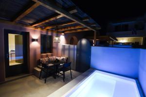 a kitchen and dining room with a table and chairs at Terra Nera Suites in Perivolos