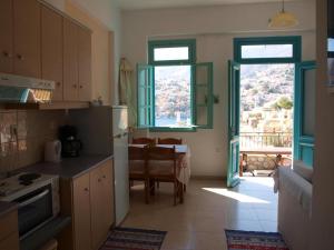 a kitchen with a table and a dining room at Andreas Apartments in Symi
